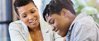 Women and student smiling and talking